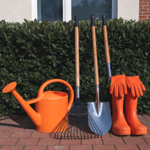 gardening-equipment-standing-next-to-house-hedge